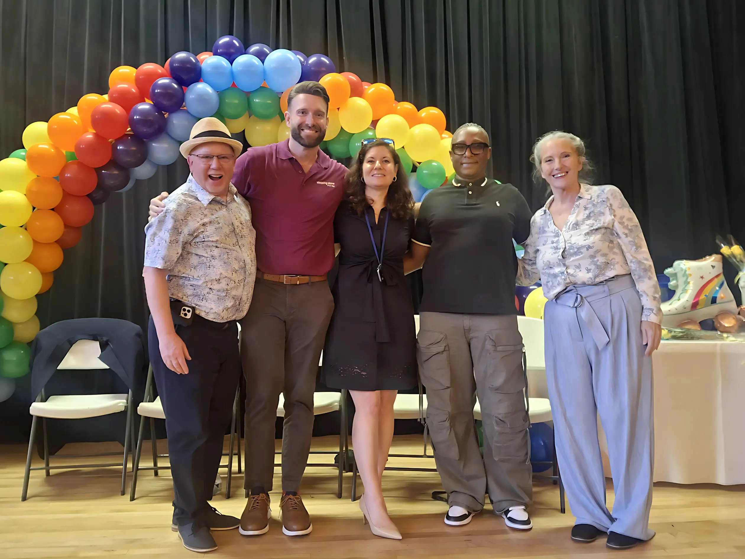 The community gathered under a rainbow balloon arch at the 2025 Celebration of Recovery