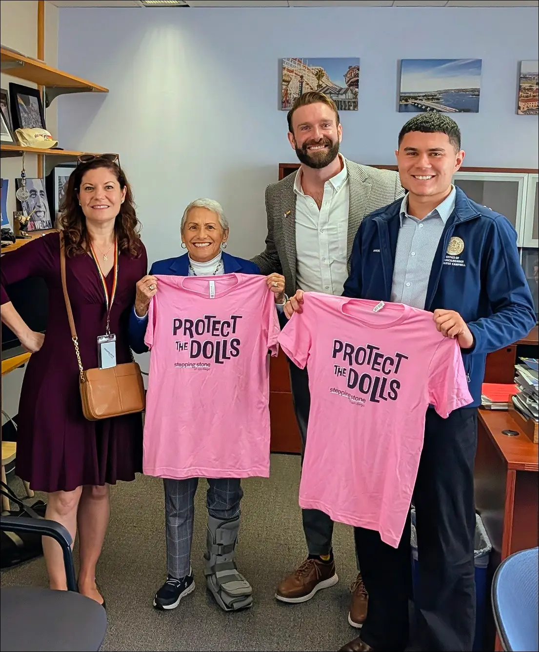 Stepping Stone staff meeting Councilmember Jennifer Campbell with Protect the Dolls shirts